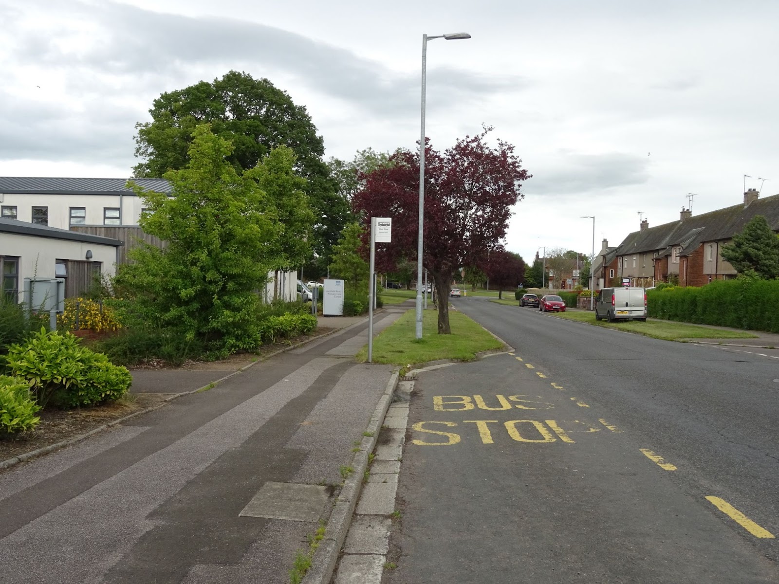 Lochfield Road looking east with a bus stop in the foreground