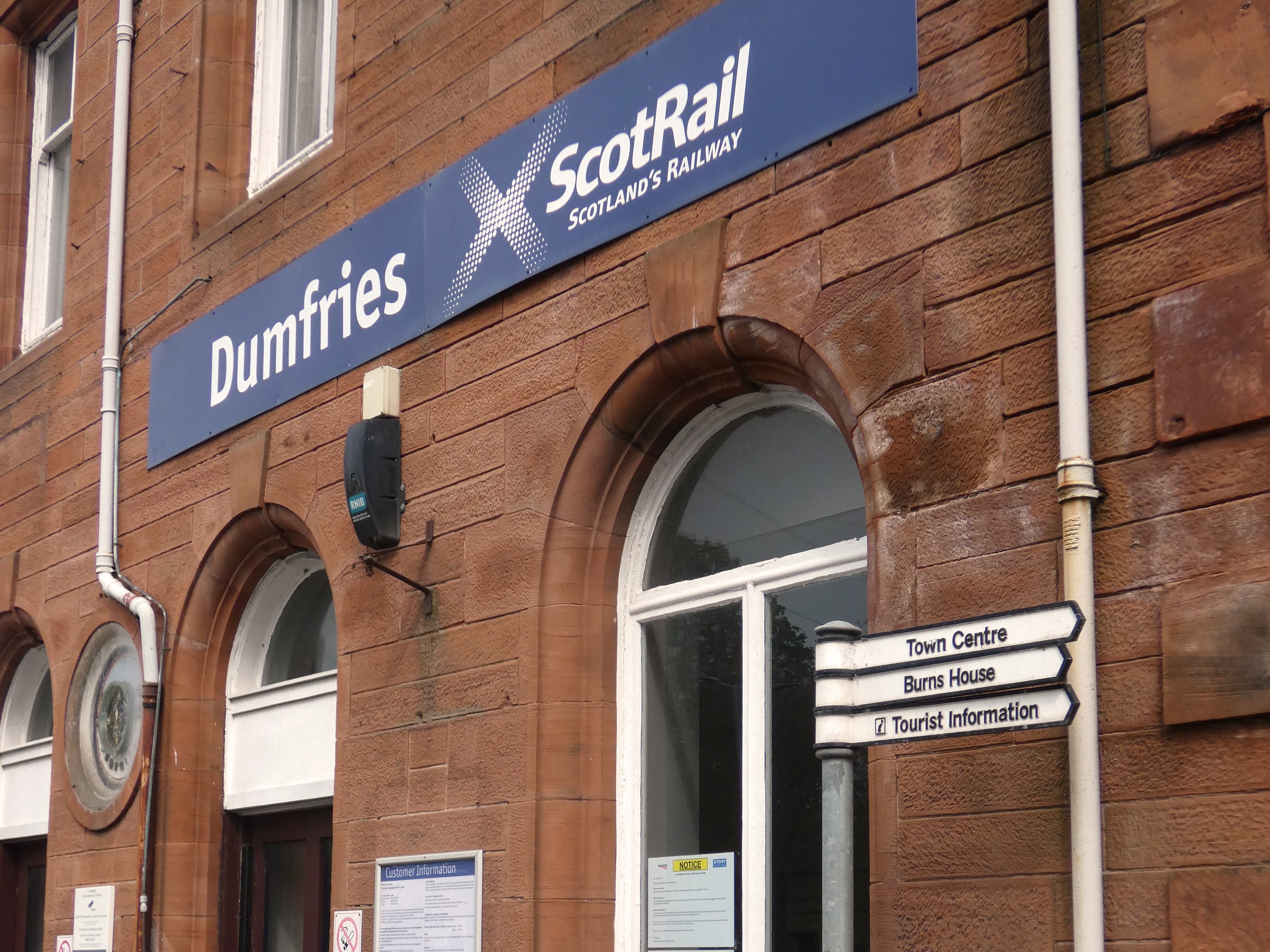 Outdated fingerpost sign outside the station