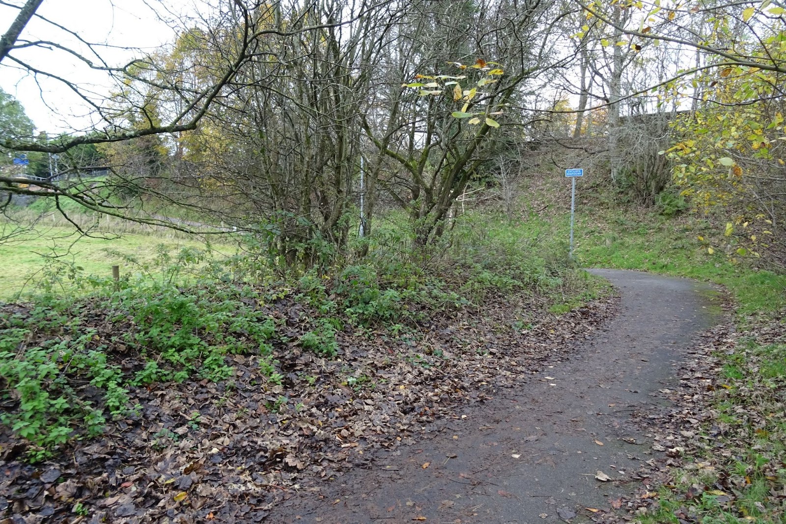 Path bending sharply round with a cyclists dismount sign