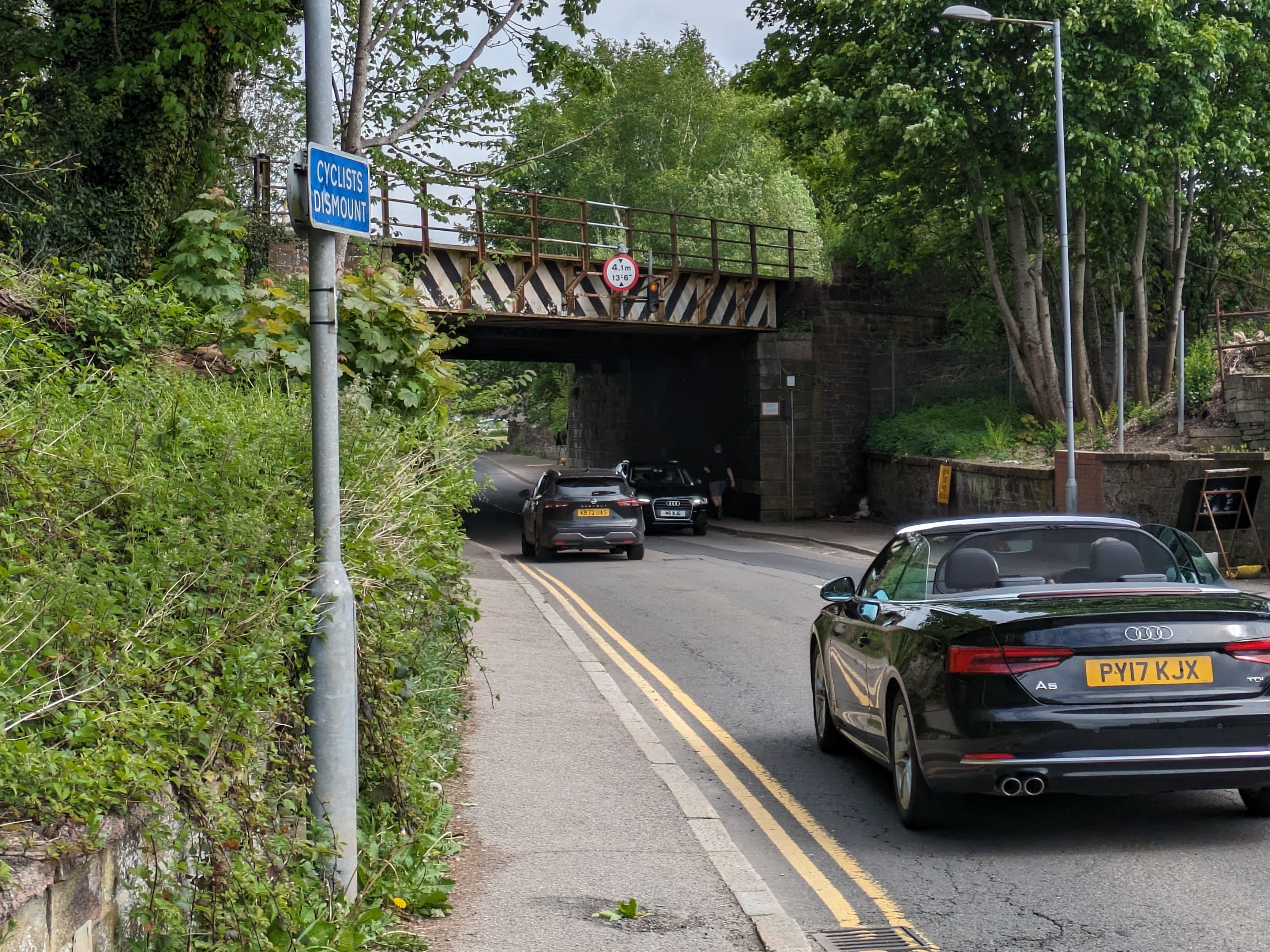 Cyclists dismount sign at the end of the Brooms Road path
