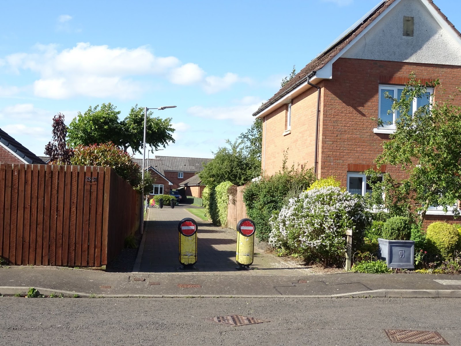 Access path between two streets with bollards and no entry signs