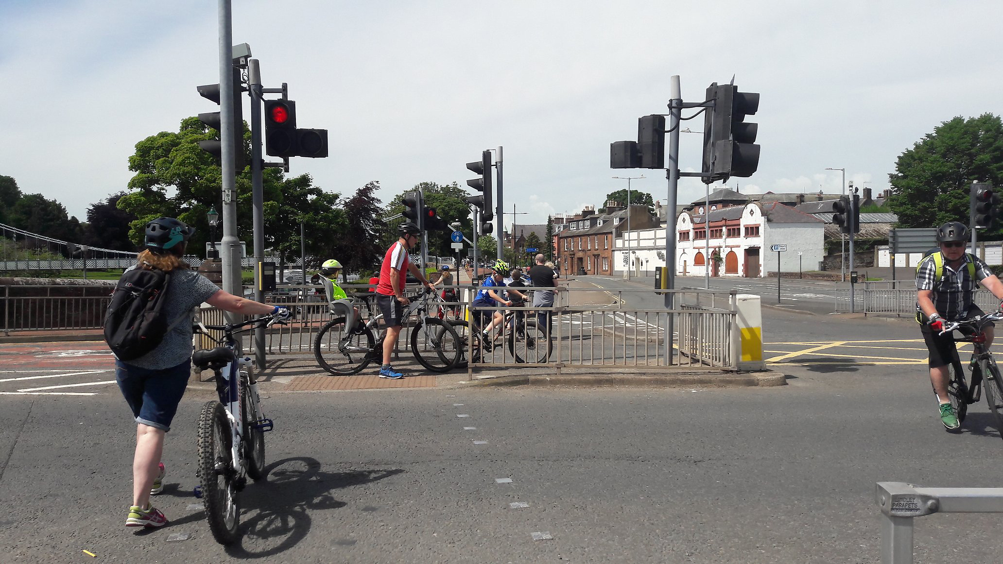 Cyclists including families with children on childseats attempting to negotiate an island in the middle of the crossing