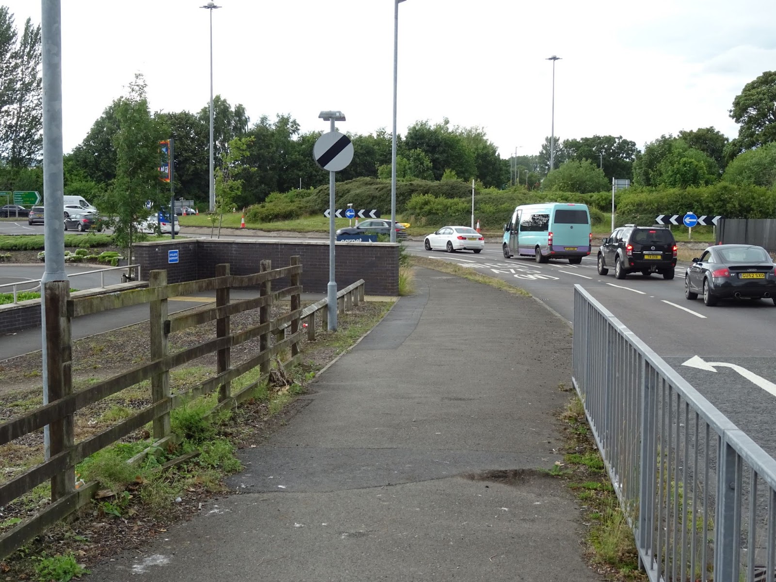 Looking towards the bypass with the entrance to Aldi and the cyclists dismount sign on the left