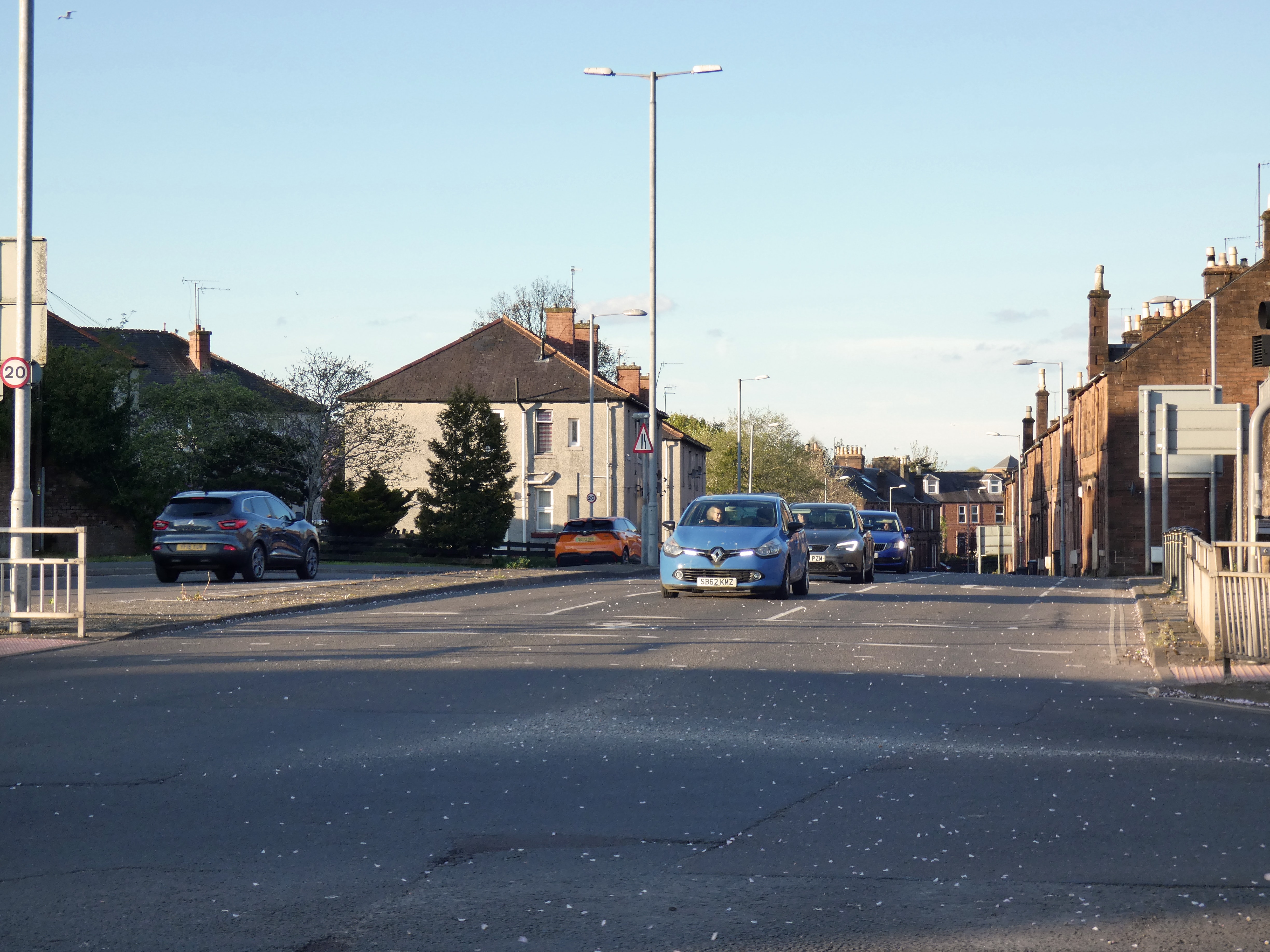 Three lanes of traffic on Brooms Road with nothing but a painted cycle lane for bikes