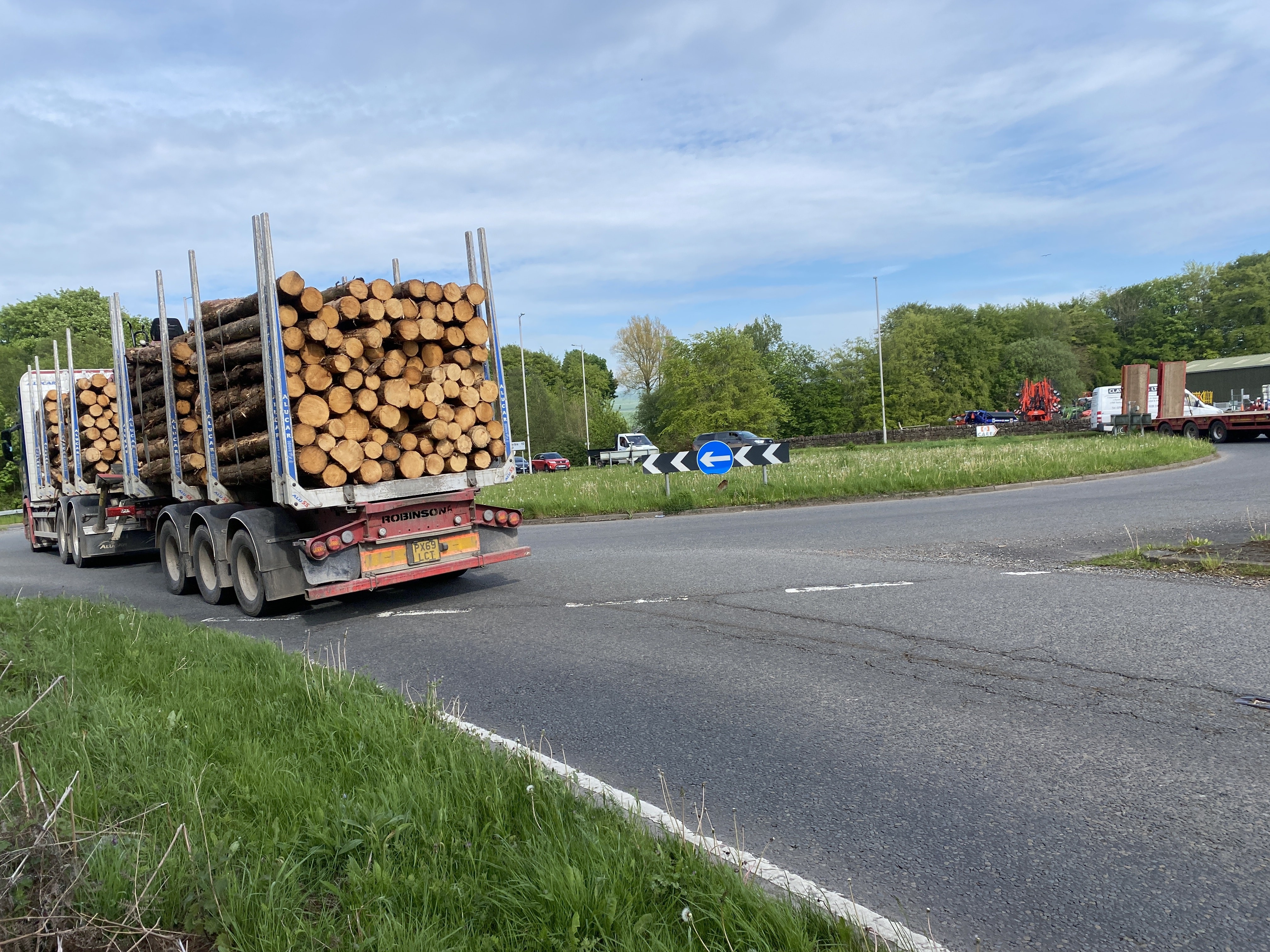 Major roundabout being used by a large timber lorry