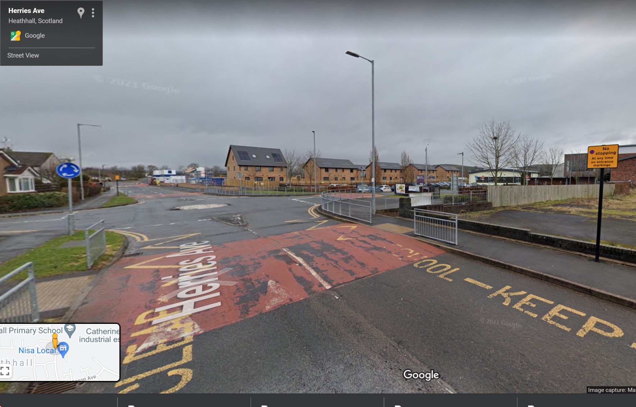The streets around the school with pedestrian barriers and wide streets