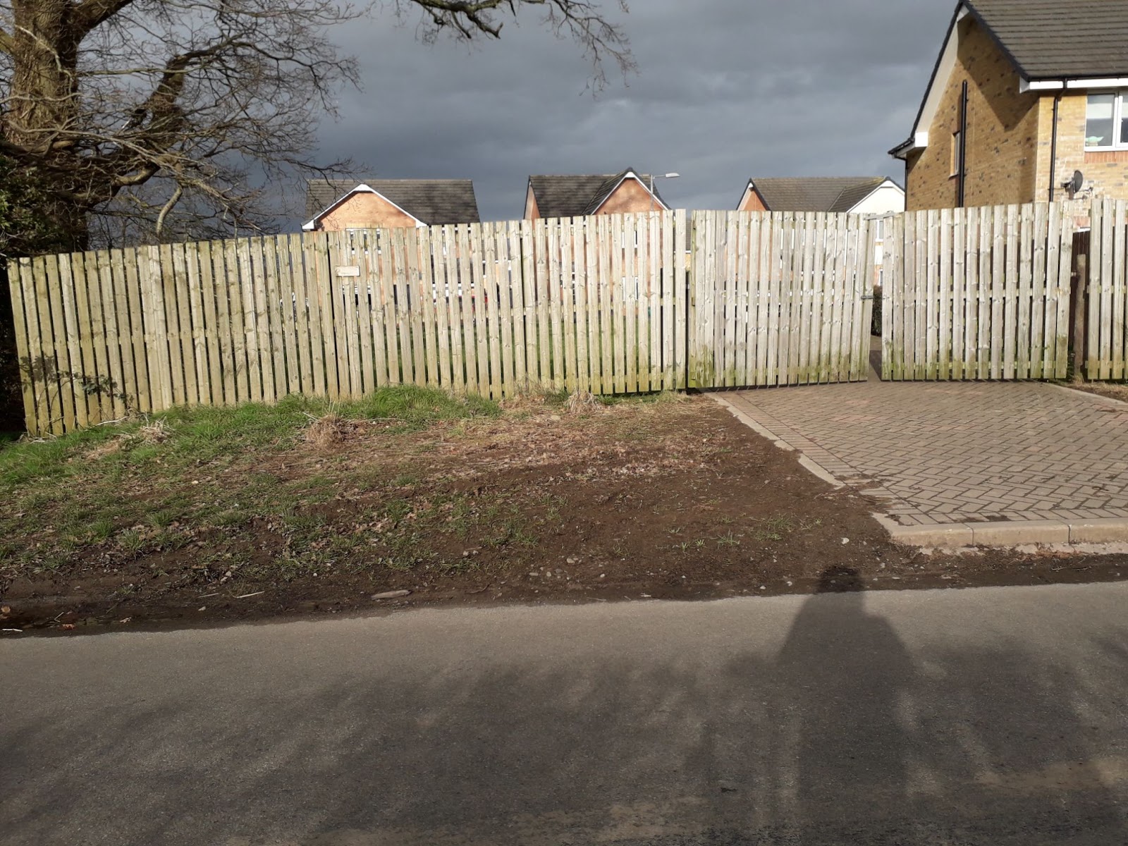 Wooden fence and partly closed gate blocking access to the Barnhill area