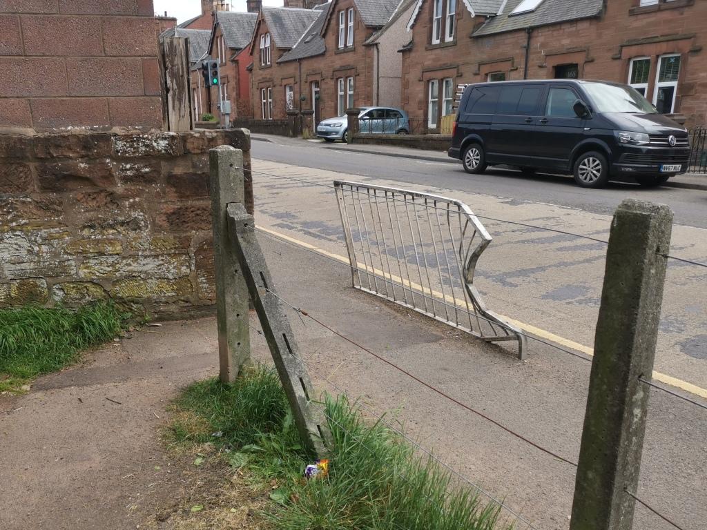 Damaged pedestrian barrier at the entrance to the park on the Annan Road