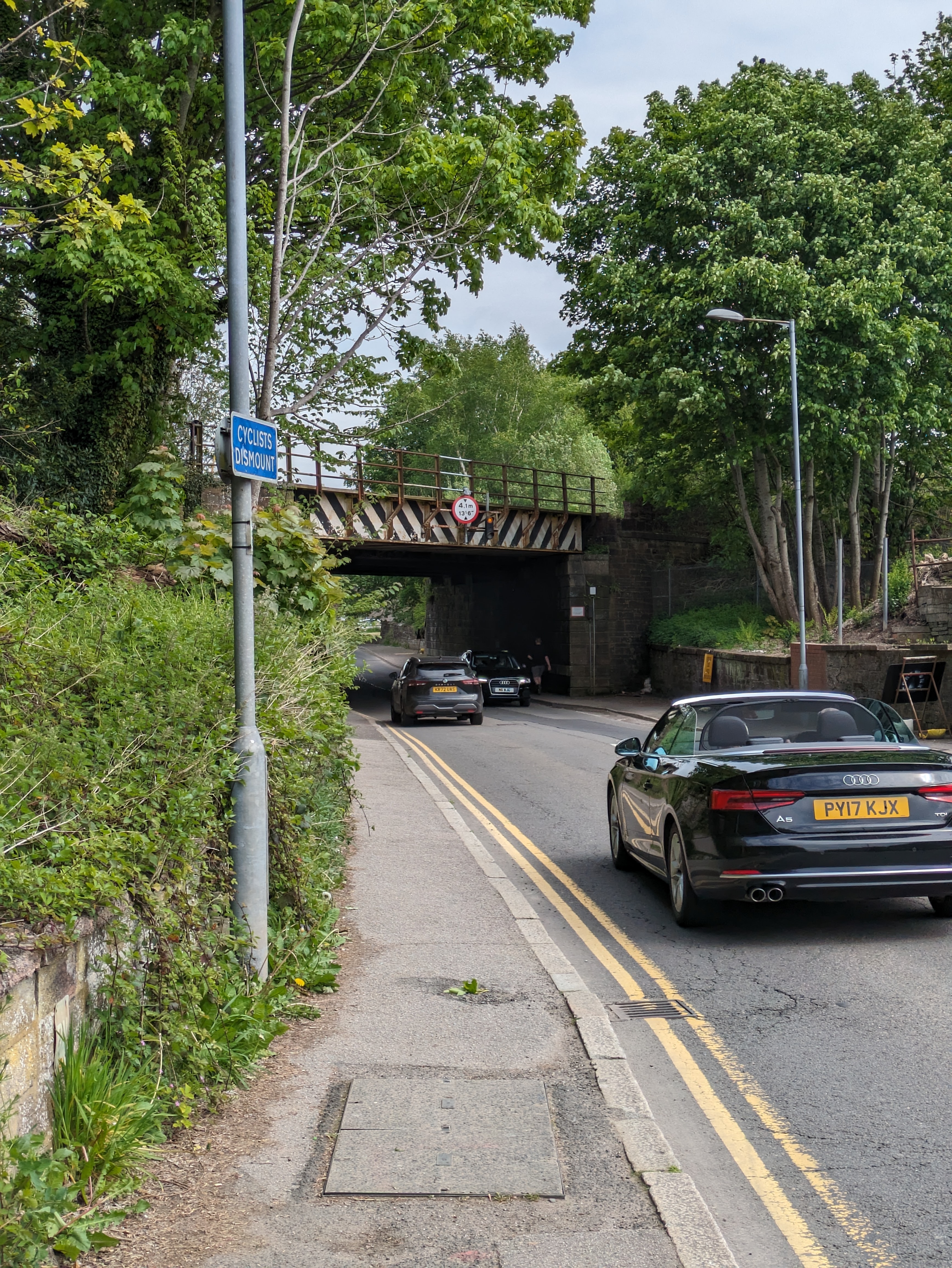 Cyclists dismount sign at the end of the Brooms Road path