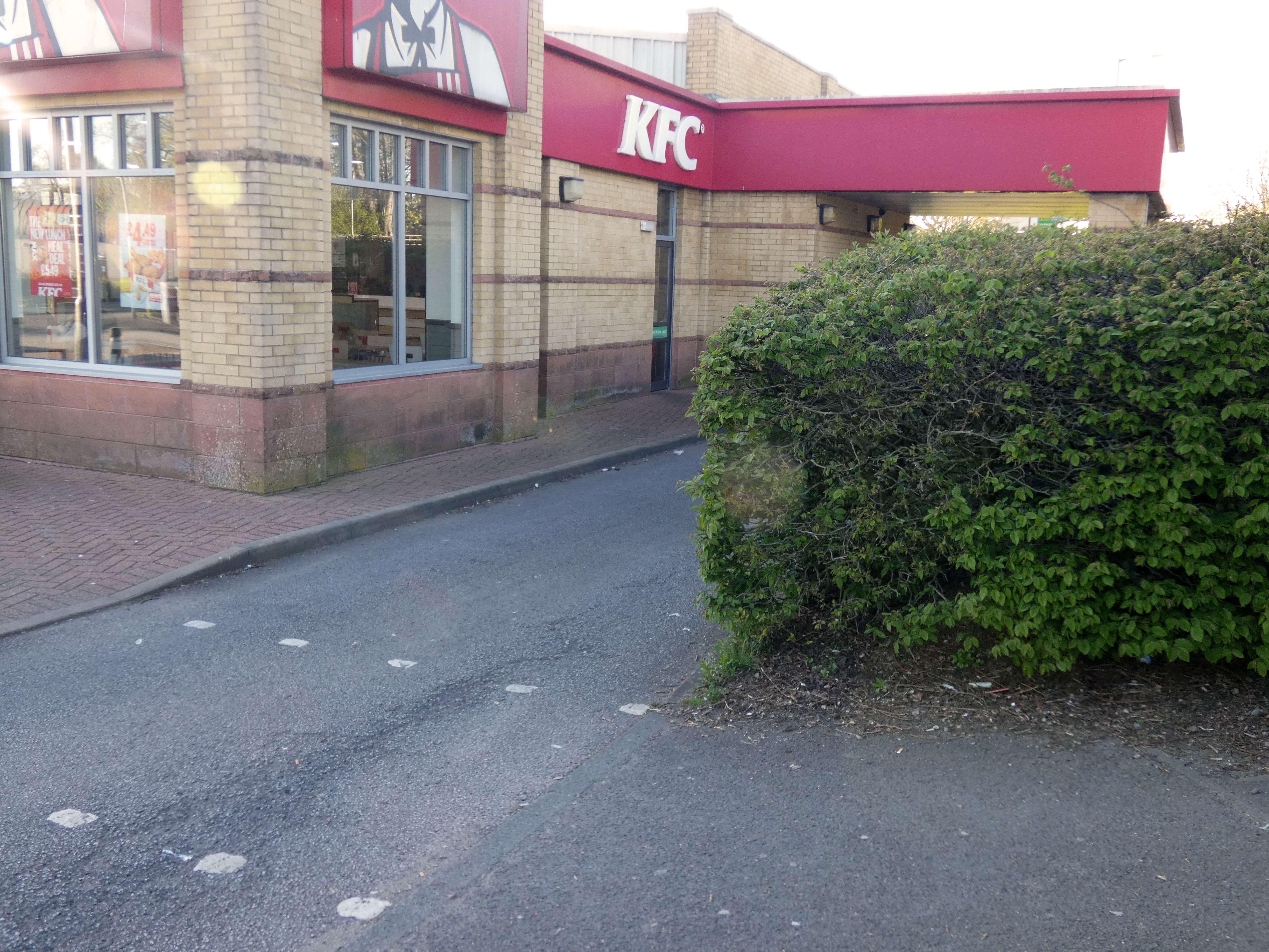Path and crossing right by a KFC drive-through exit